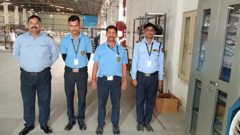 Four VSS security guards in uniform at a client site