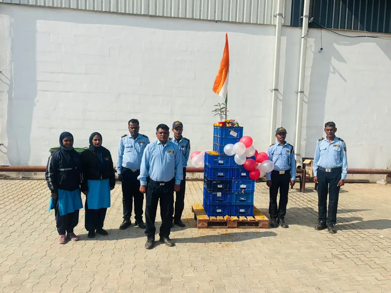 VSS guards and housekeeping staff at a site celebration with the Indian flag
